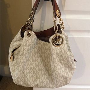 White Michael Kors purse and wallet.